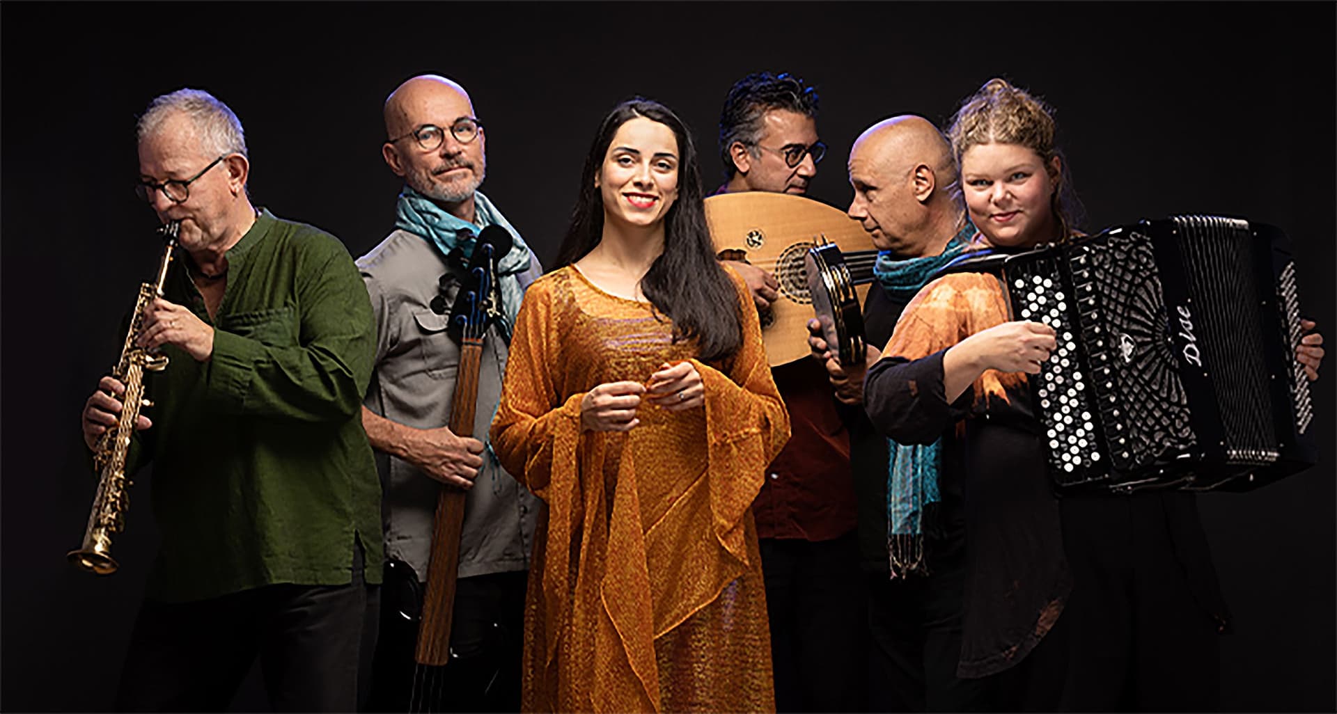 Photograph of six people with instruments against a black background