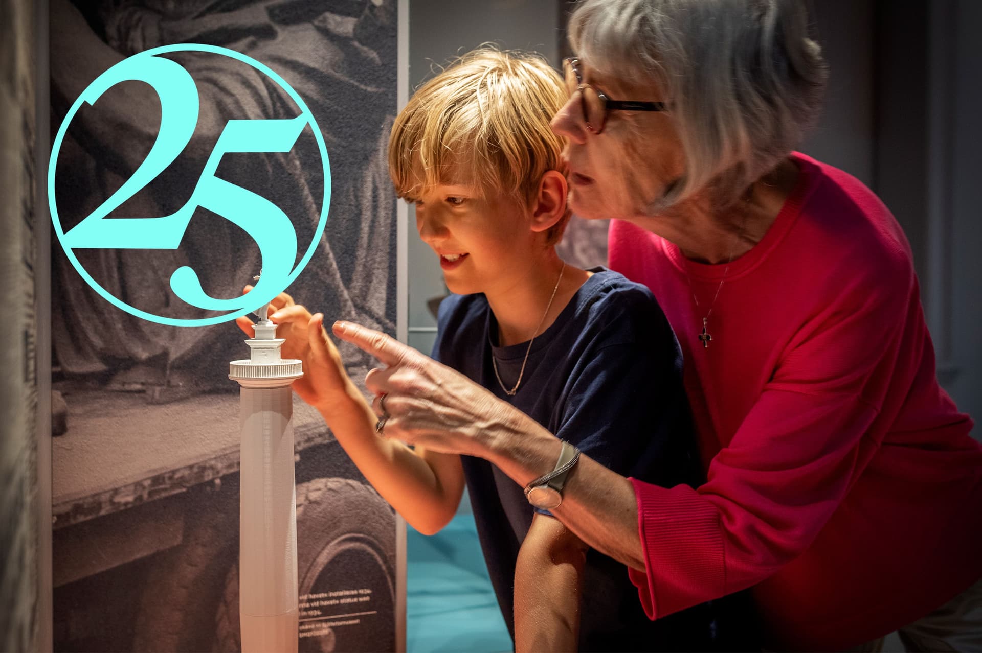 Child and elderly person pointing at artwork