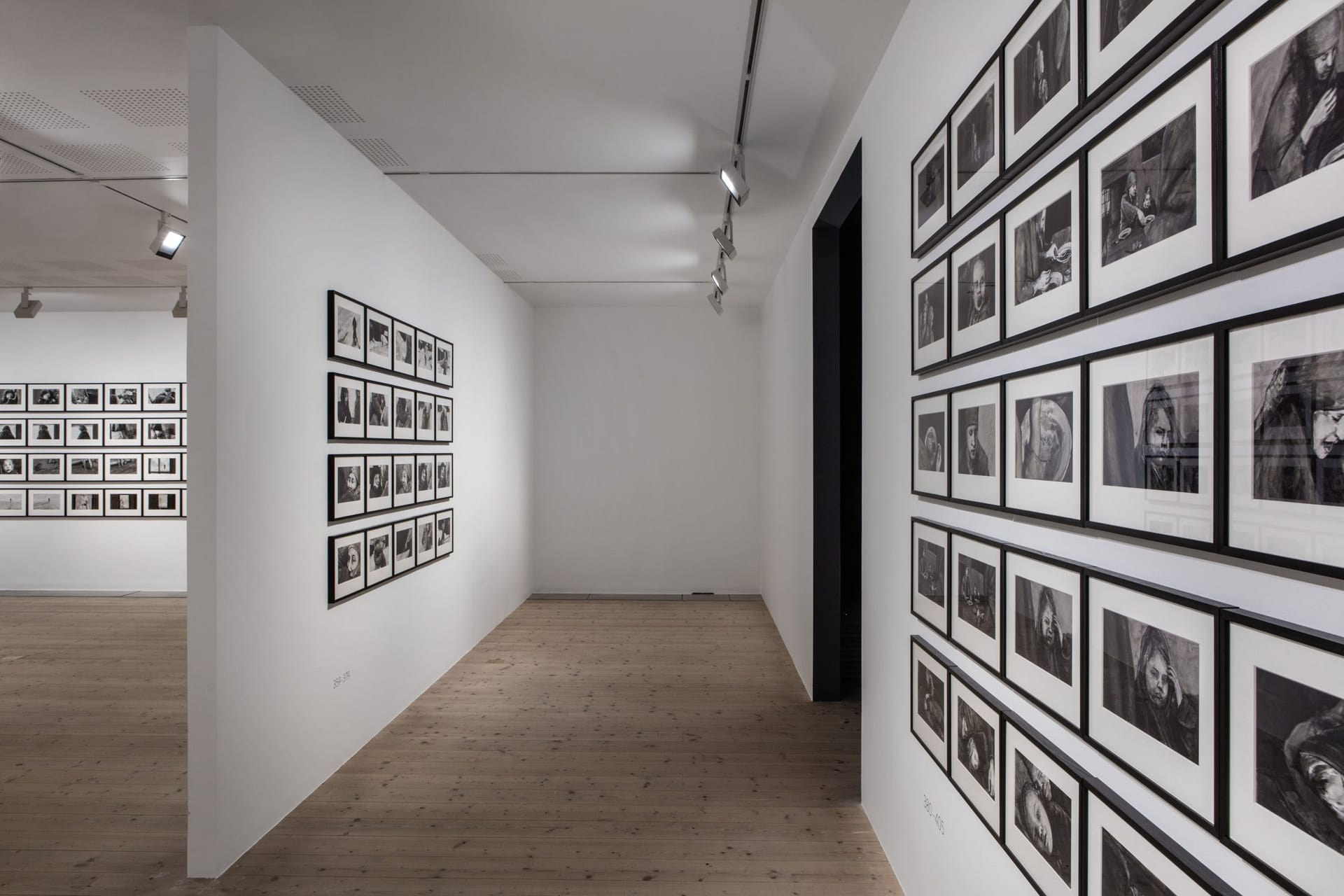 White walls covered with several paintings in black and white