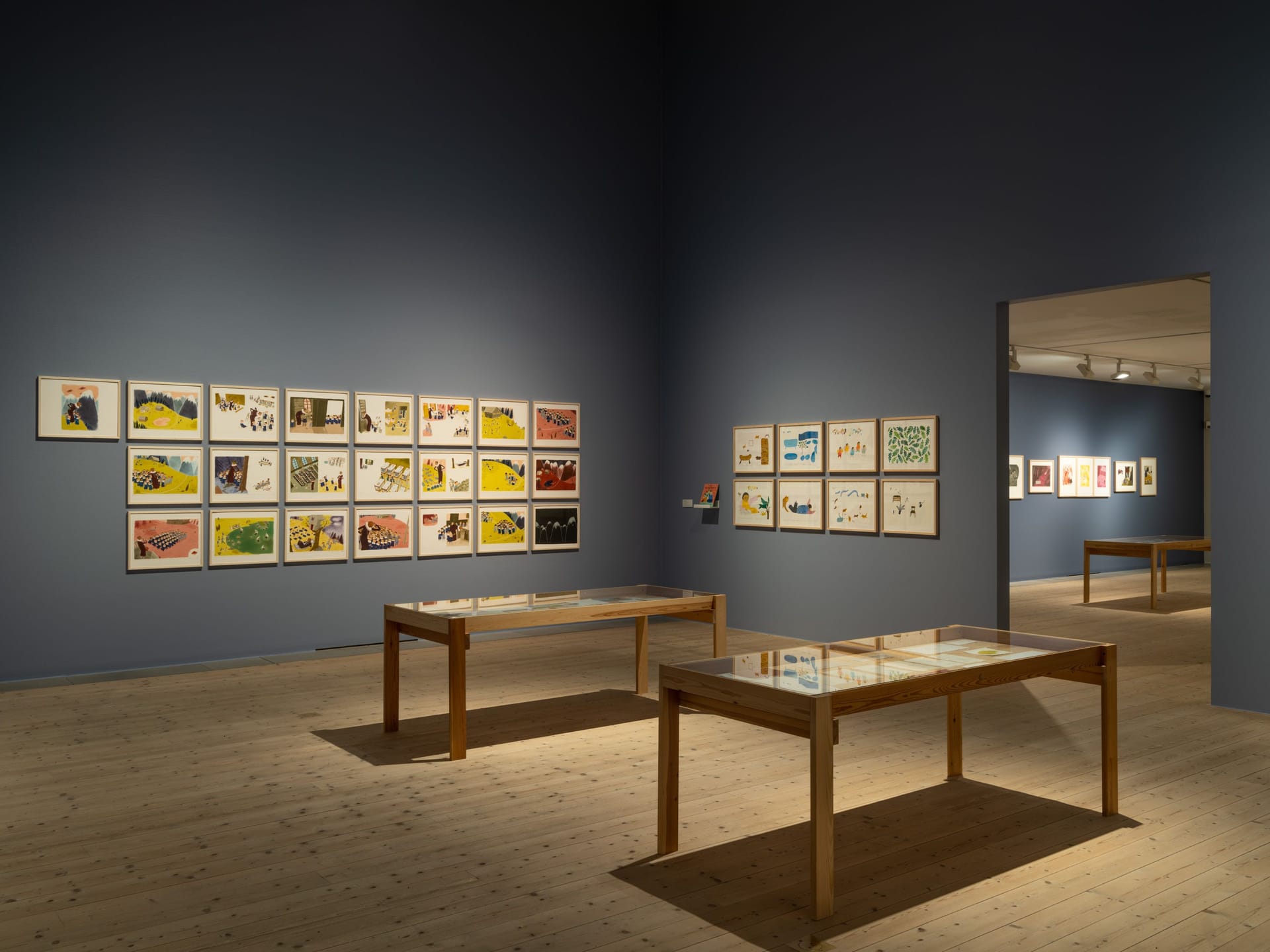 Exhibition room with framed images and display cases