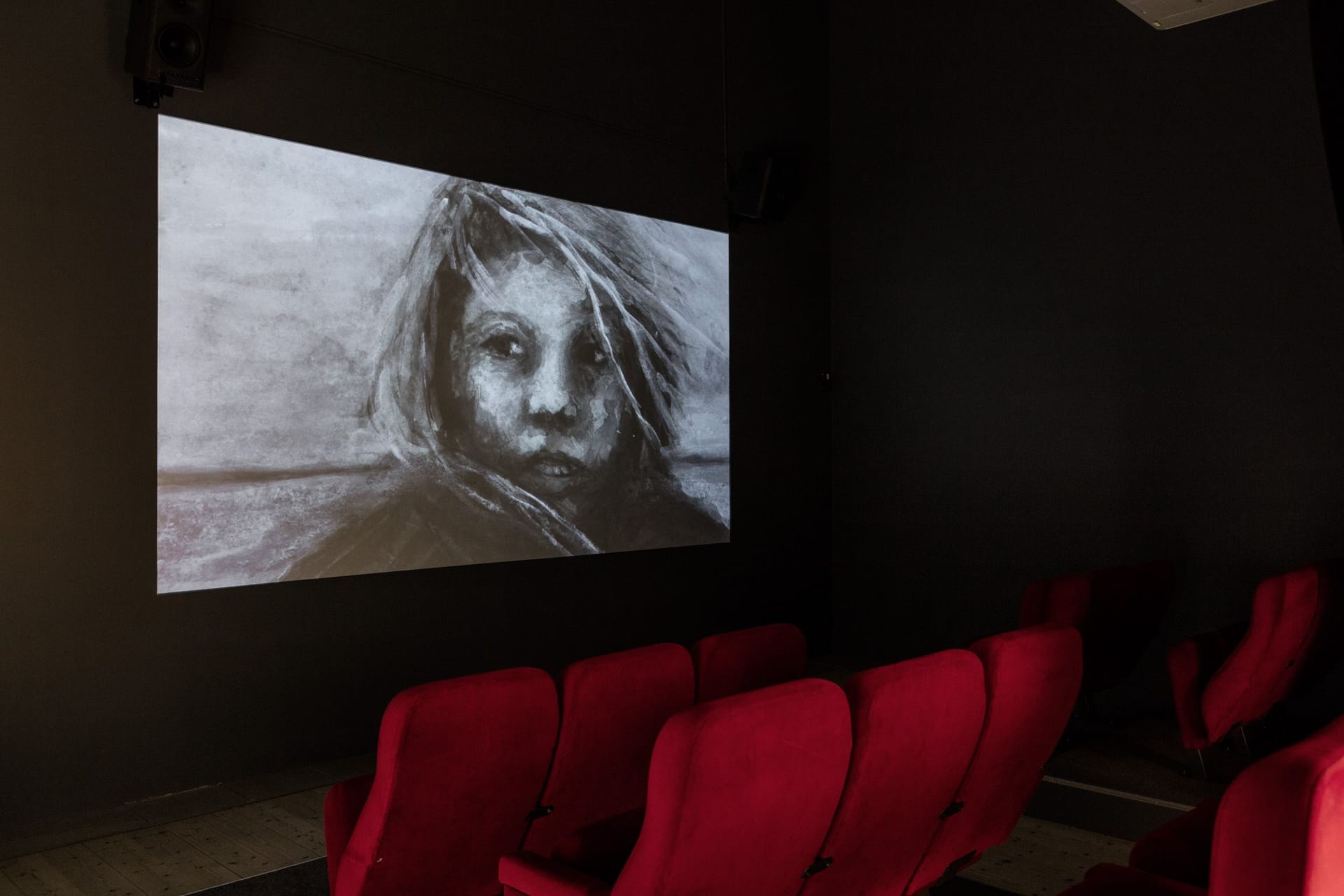  Photo of cinema screen with watercolour in black and white, in the foreground red cinema seats