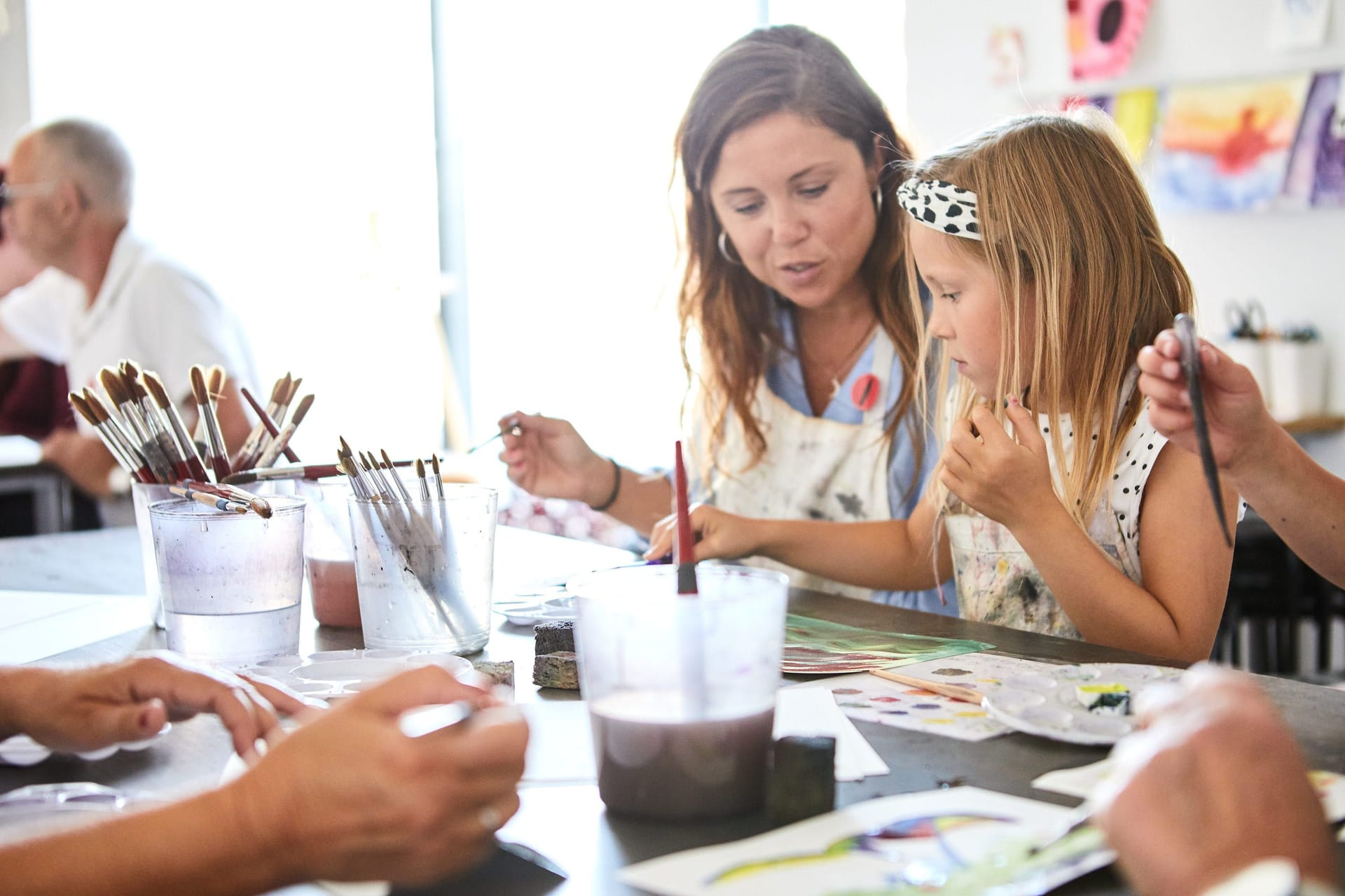 Adult and kid painting together