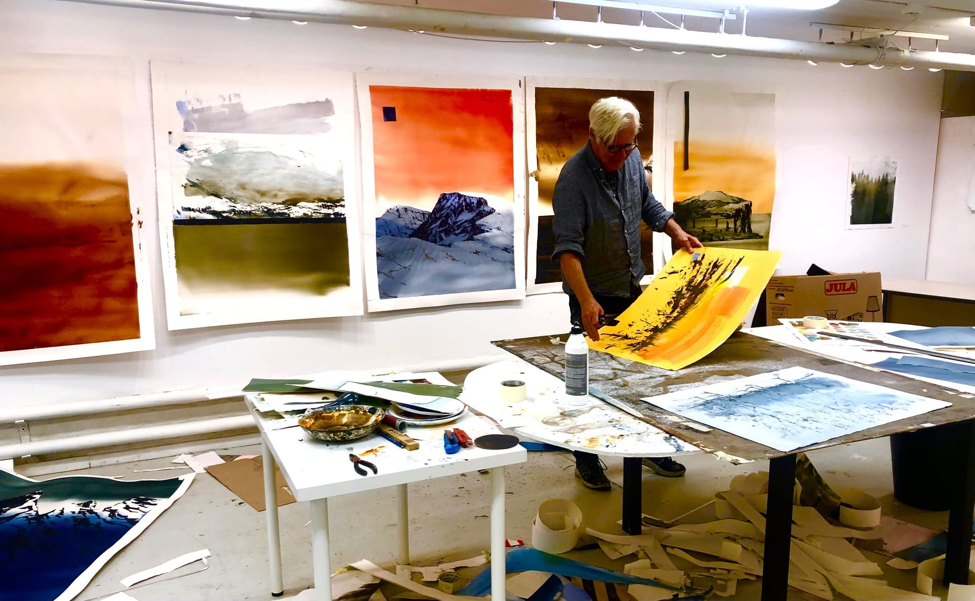 Lars A Persson in the studio, in front of lots of the picture on a bprd