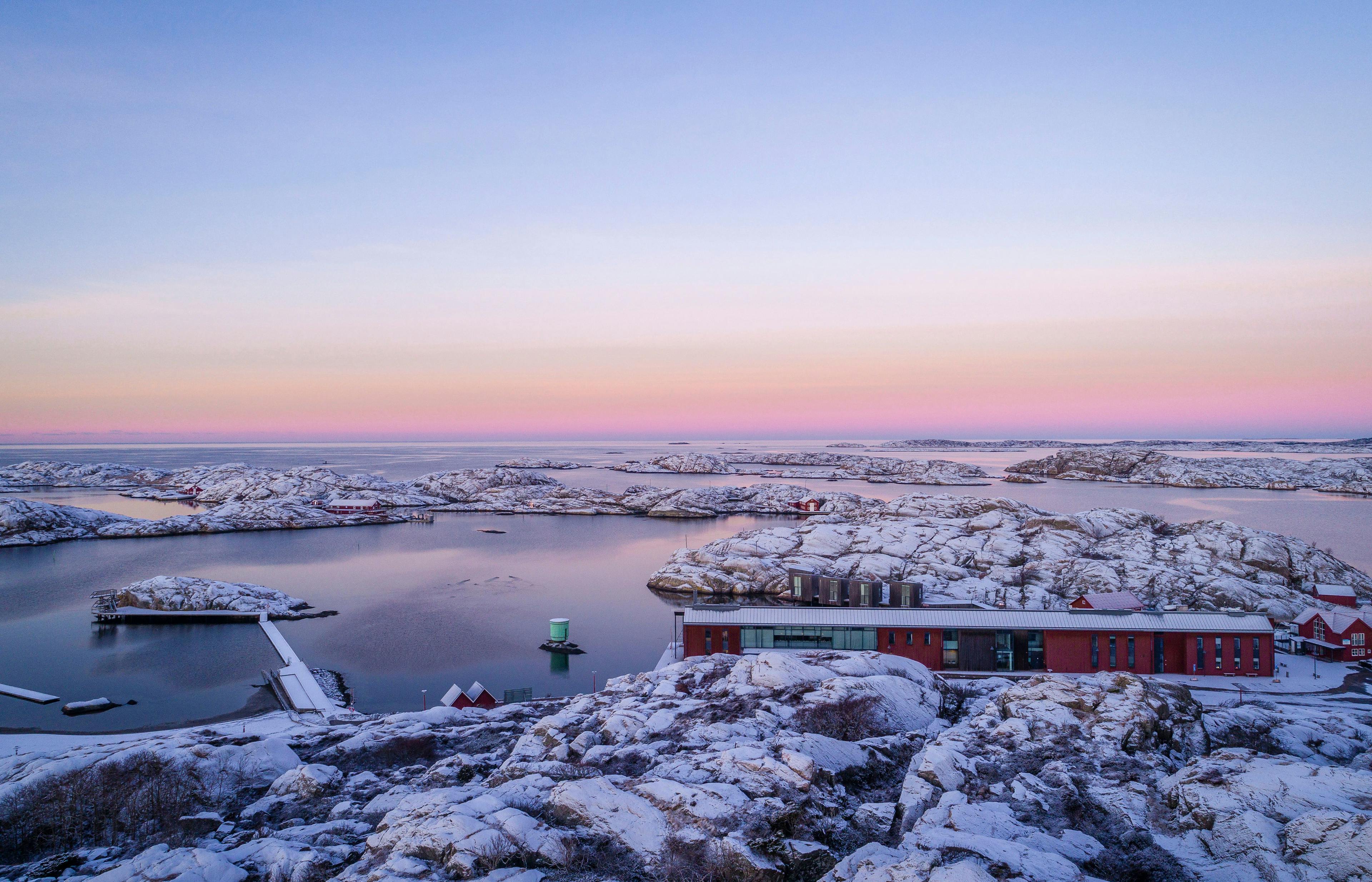 The museum in a snow-covered archipelago, with dim, rose-tinged light from the sky