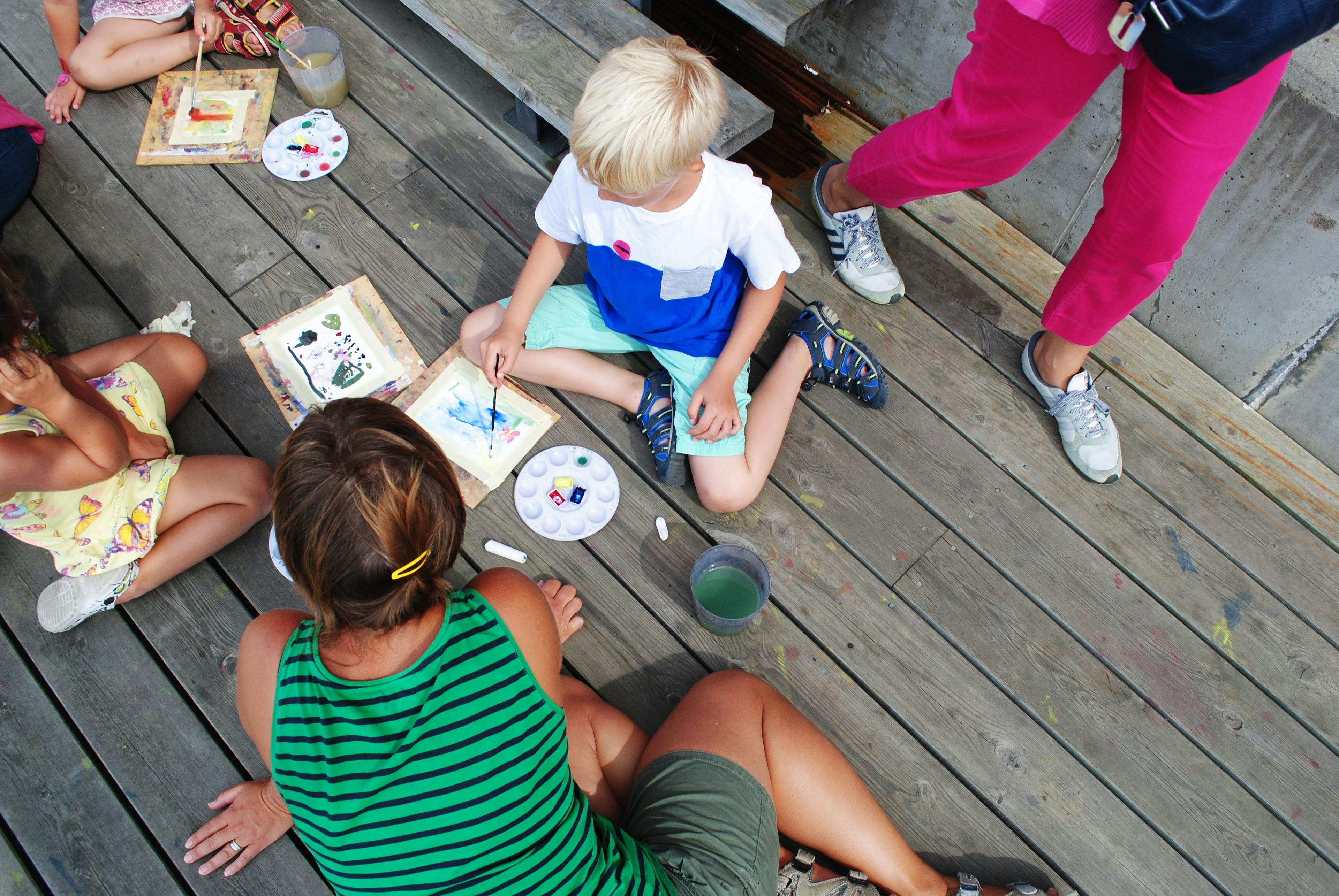 Kids painting on the dock