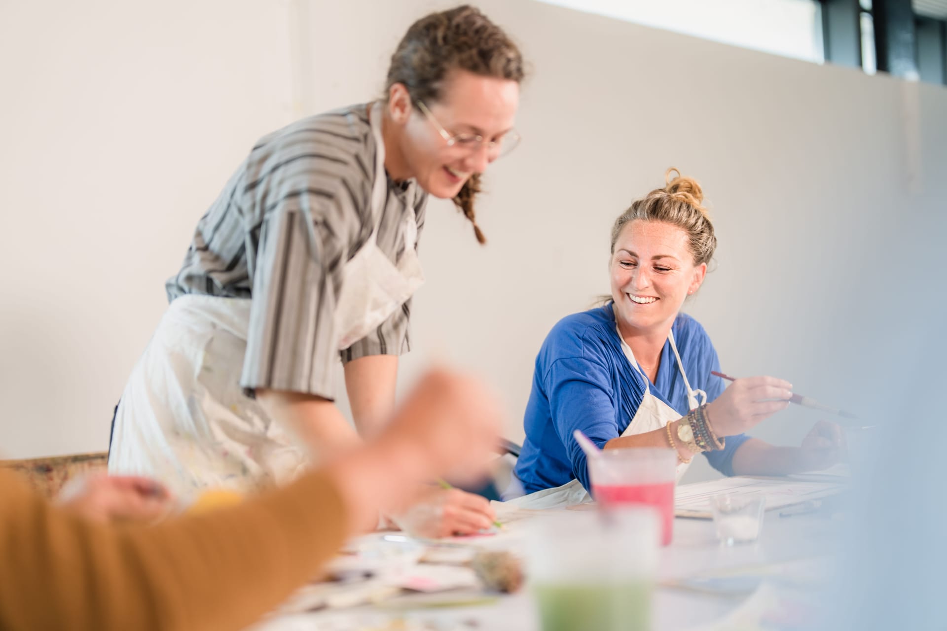 Two people painting and laughing