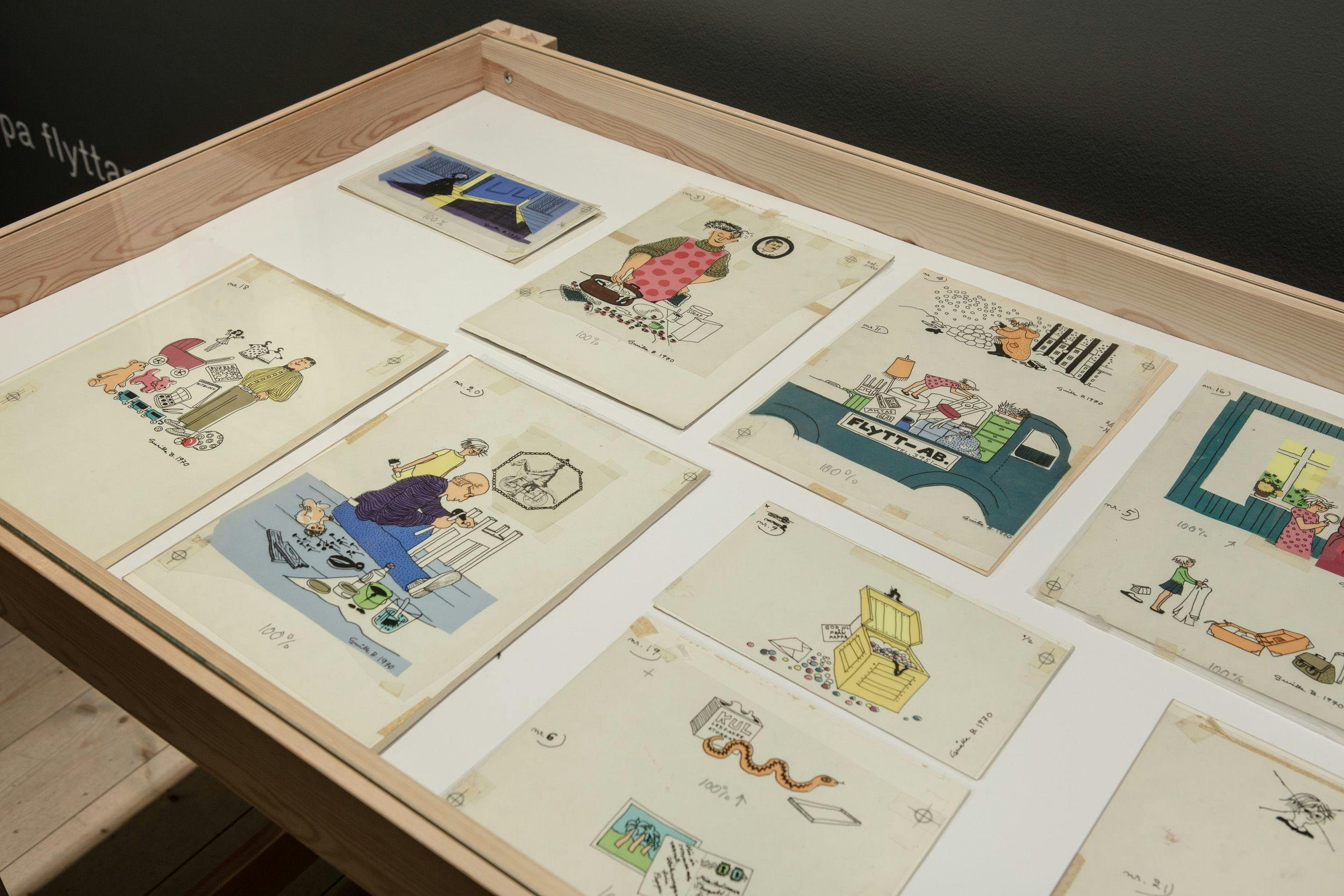 Close-up of pictures in show case, sketches from the book Bill and Bolla