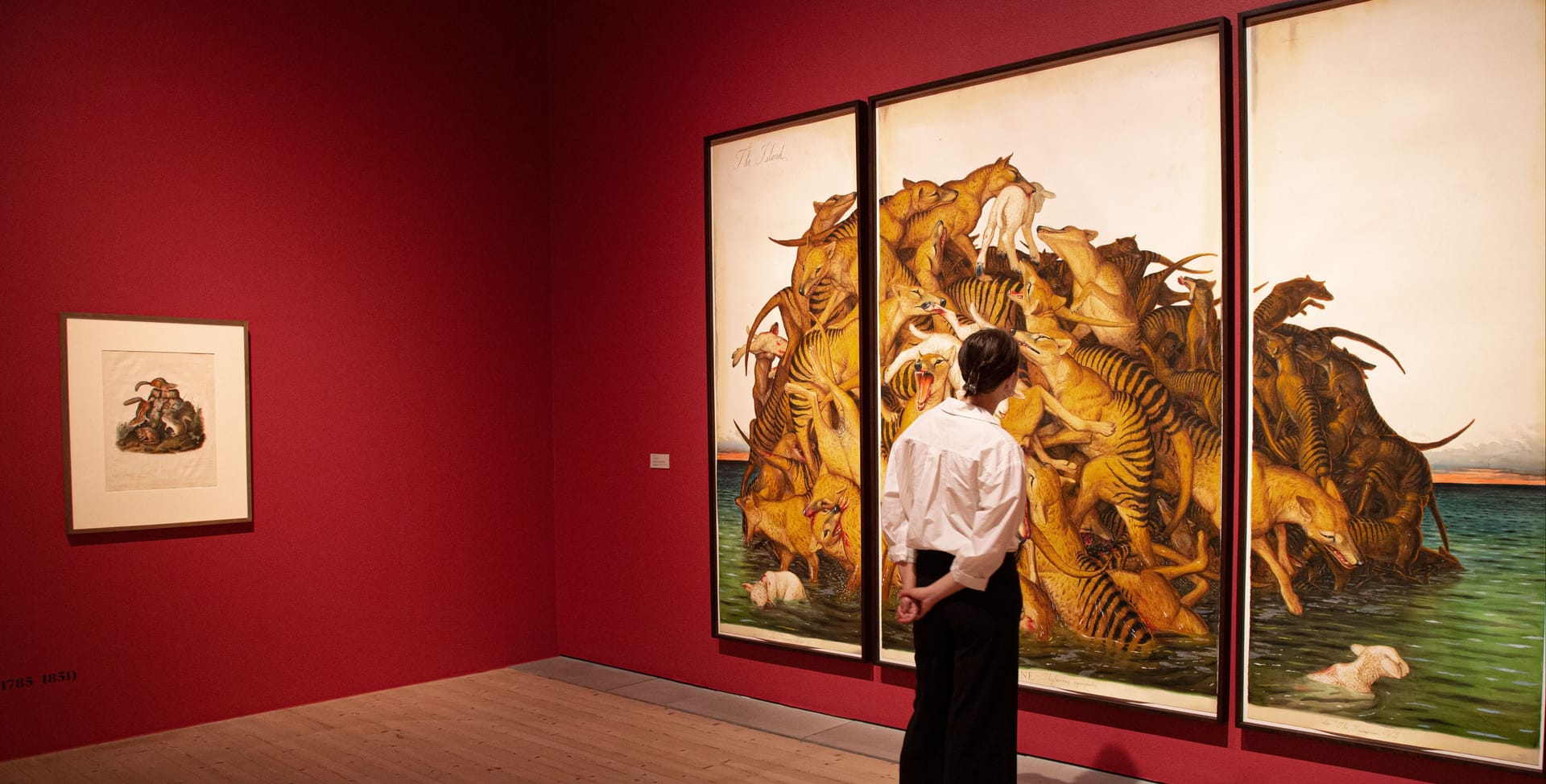 Visitors in front of an art work by Walton Ford