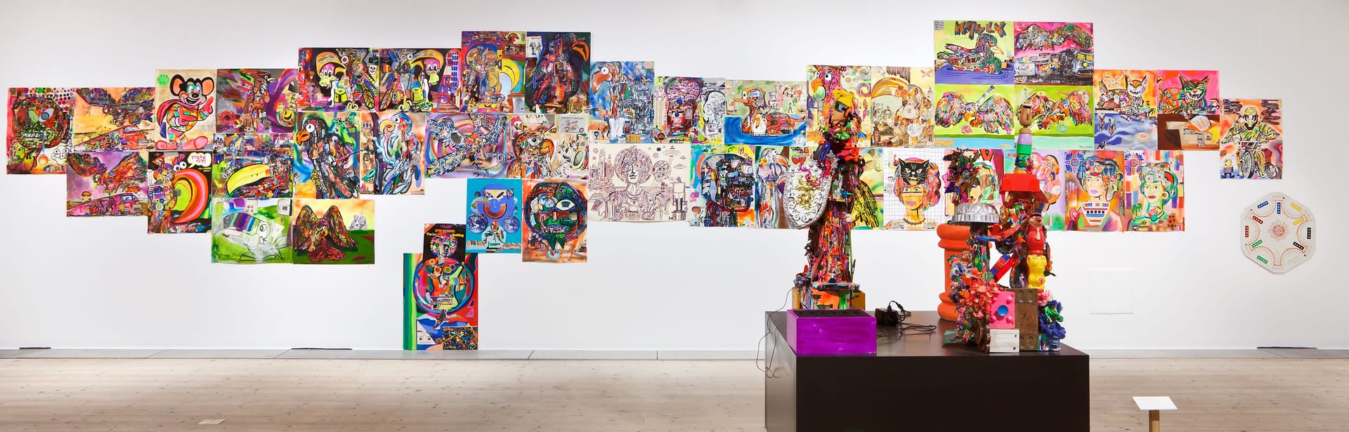 Exhibition room with paintings and sculptures by Joe Grillo