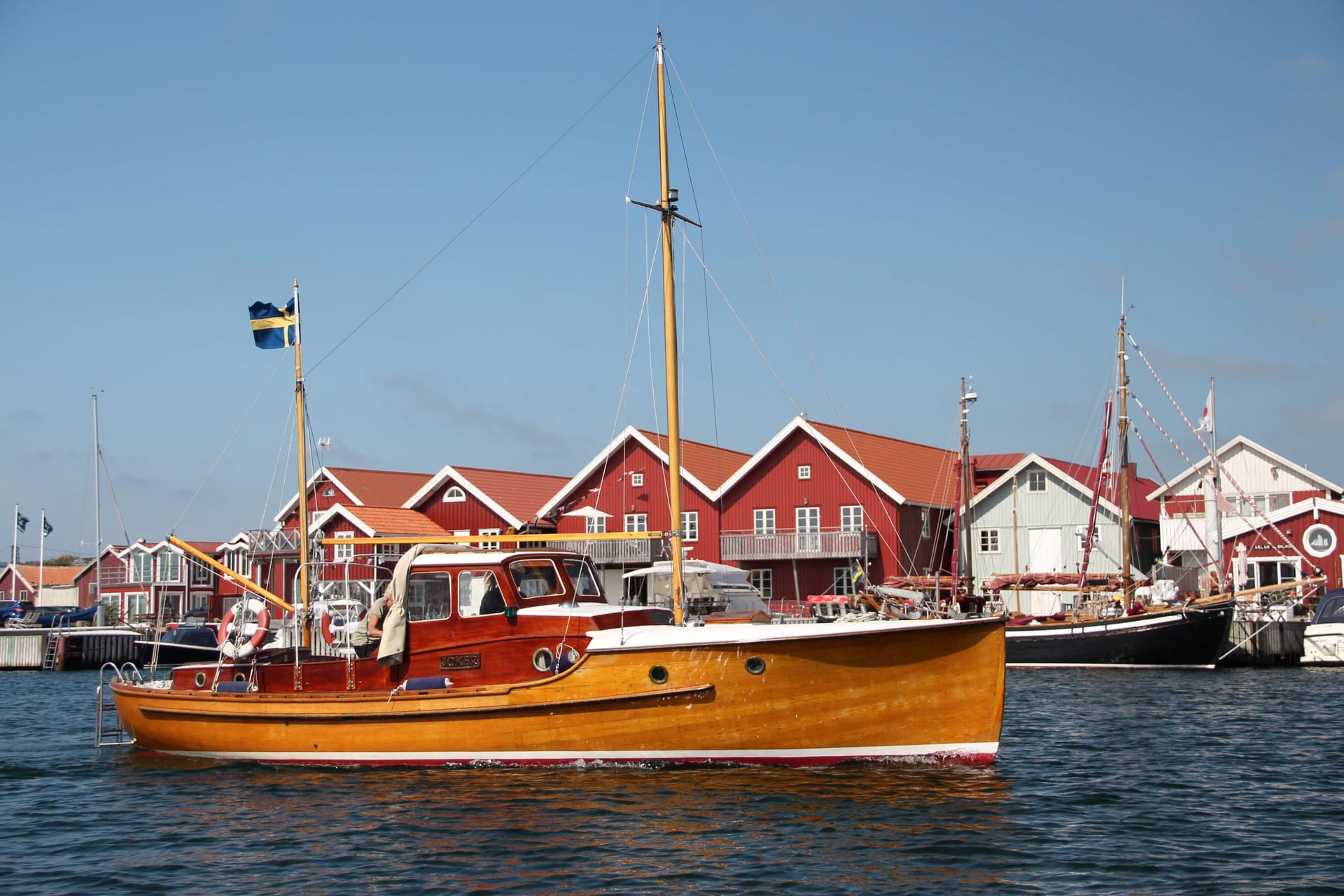 Wooden boat driving in the harbor