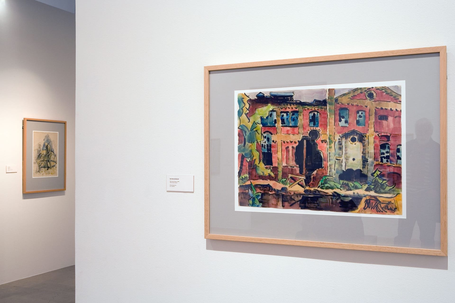 Exhibition room with colourful painting by Karl Schmidt-Rottluff in the foreground