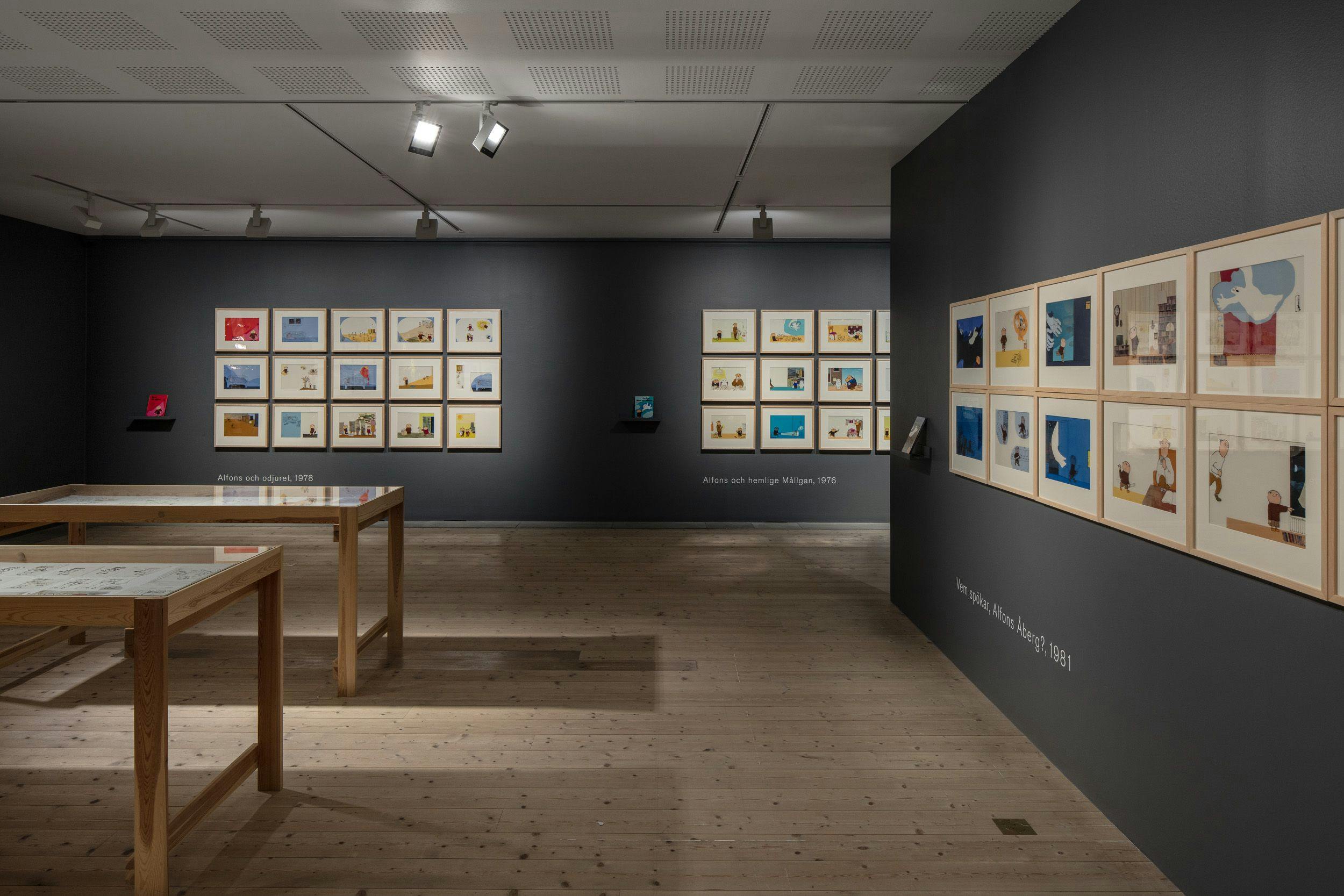 Photo of a room with pictures from Alfons Åberg on the walls and in two showcases