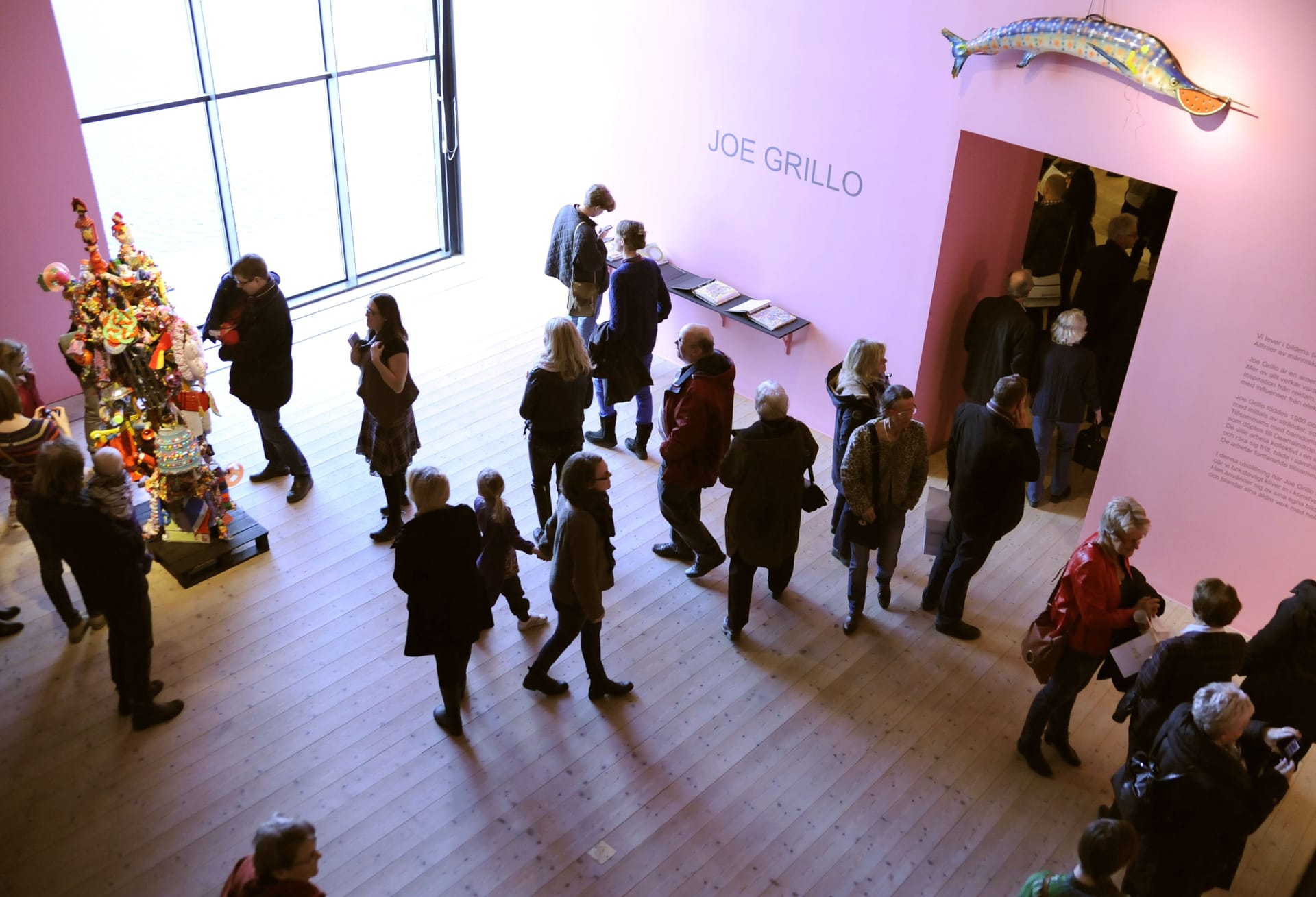 Visitors in pink exhibition room