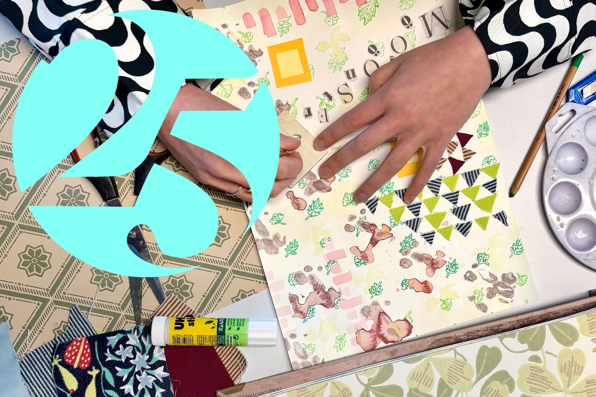 Hands working with patterned paper