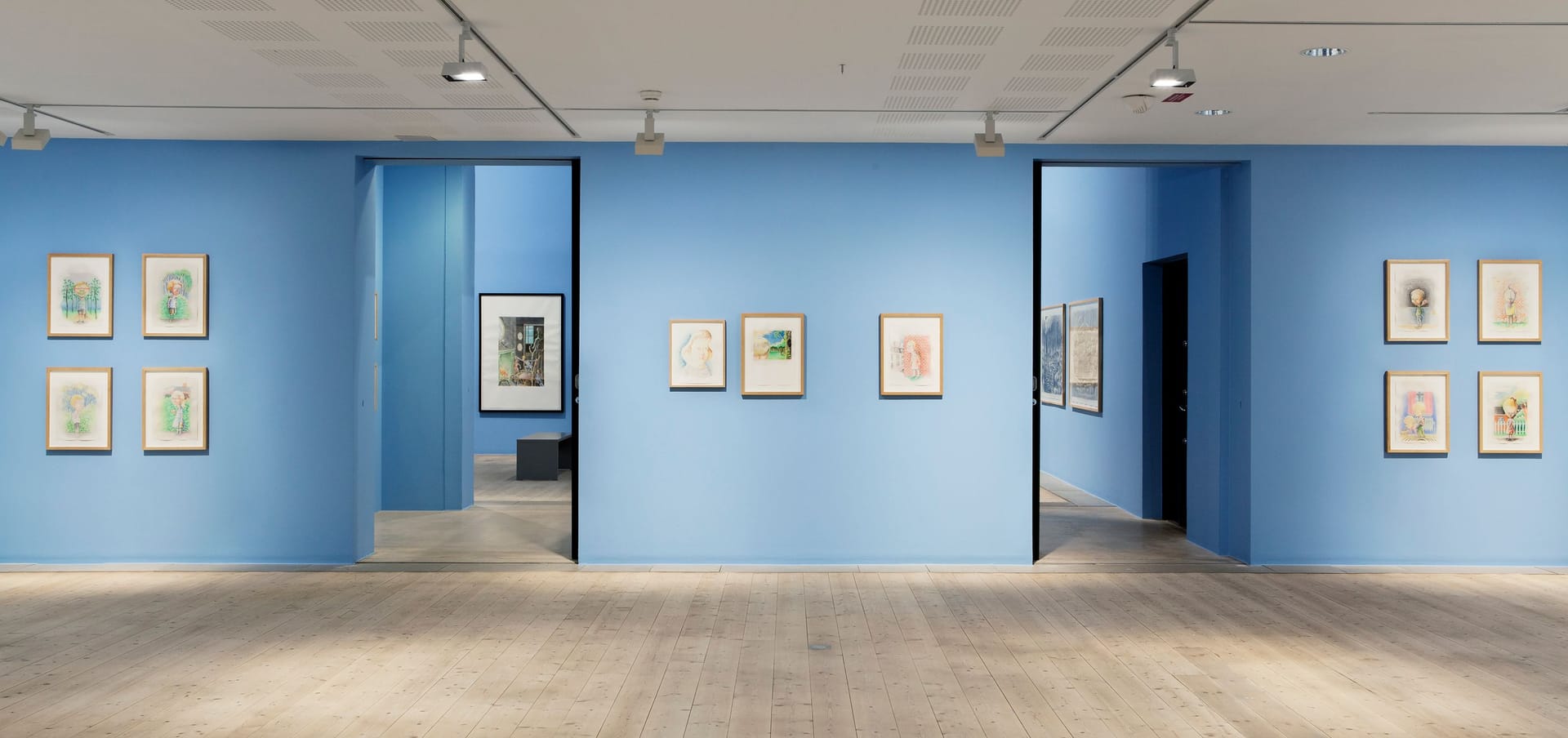 Light blue walls with paintings by Peter Land.